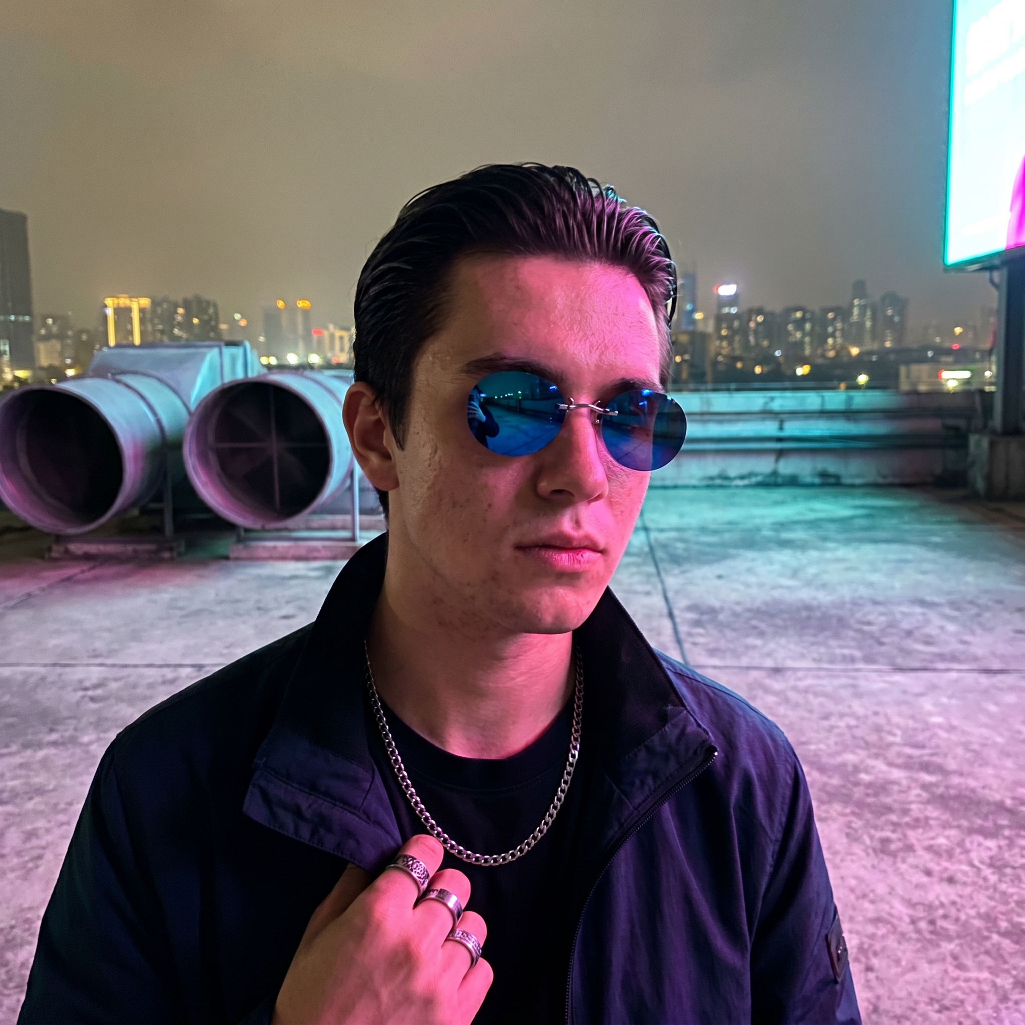 Round rimless clip-on sunglasses in blue mirror worn on a rooftop under a glowing billboard