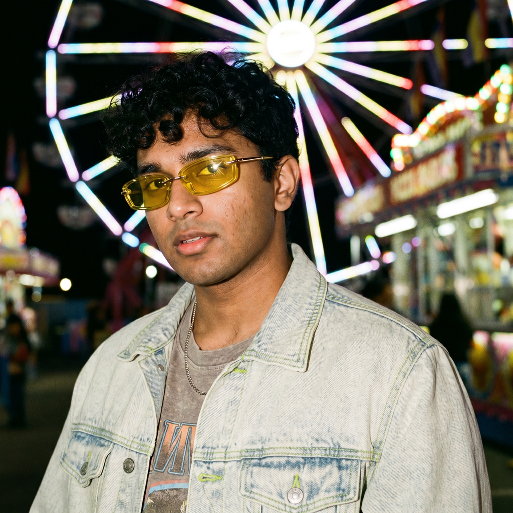 Swervy Vision Y2K rimless shades in yellow worn at a night carnival ferris wheel