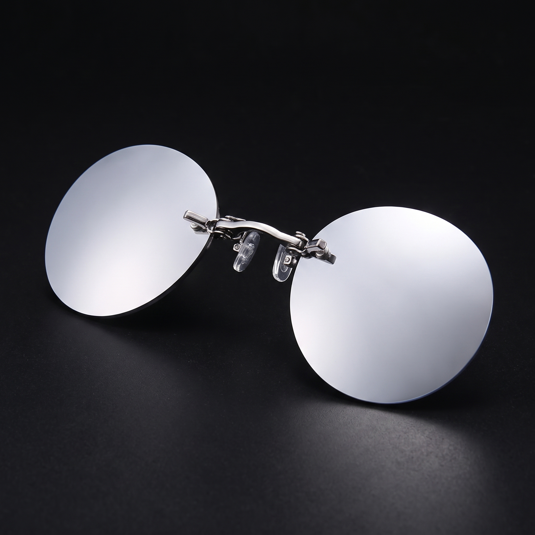 Round rimless clip-on sunglasses, silver mirror colorway, studio close-up — no temple arms