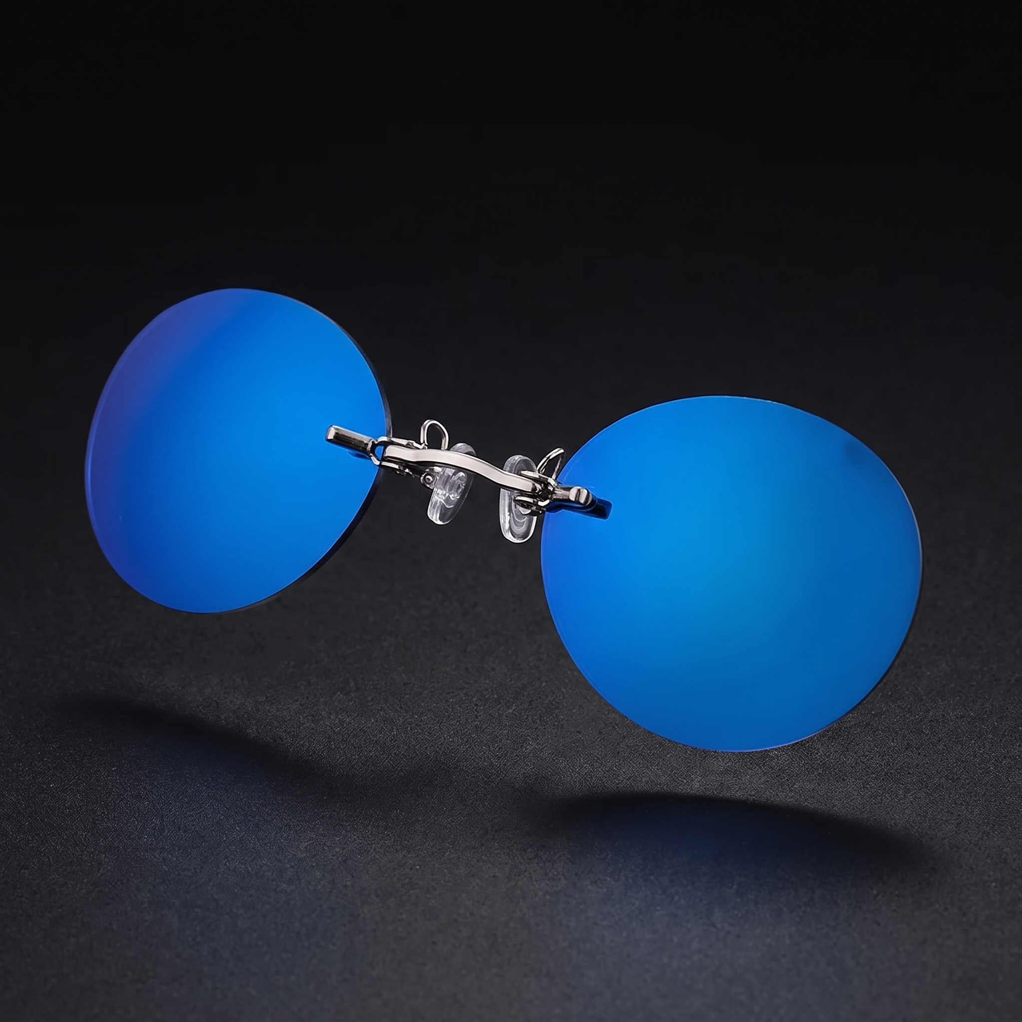 Round rimless clip-on sunglasses, blue mirror colorway, studio close-up — no temple arms