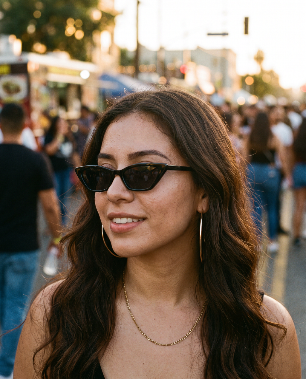 Small Cat Eye Retro 90s Sunglasses in Black worn at a block party at golden hour
