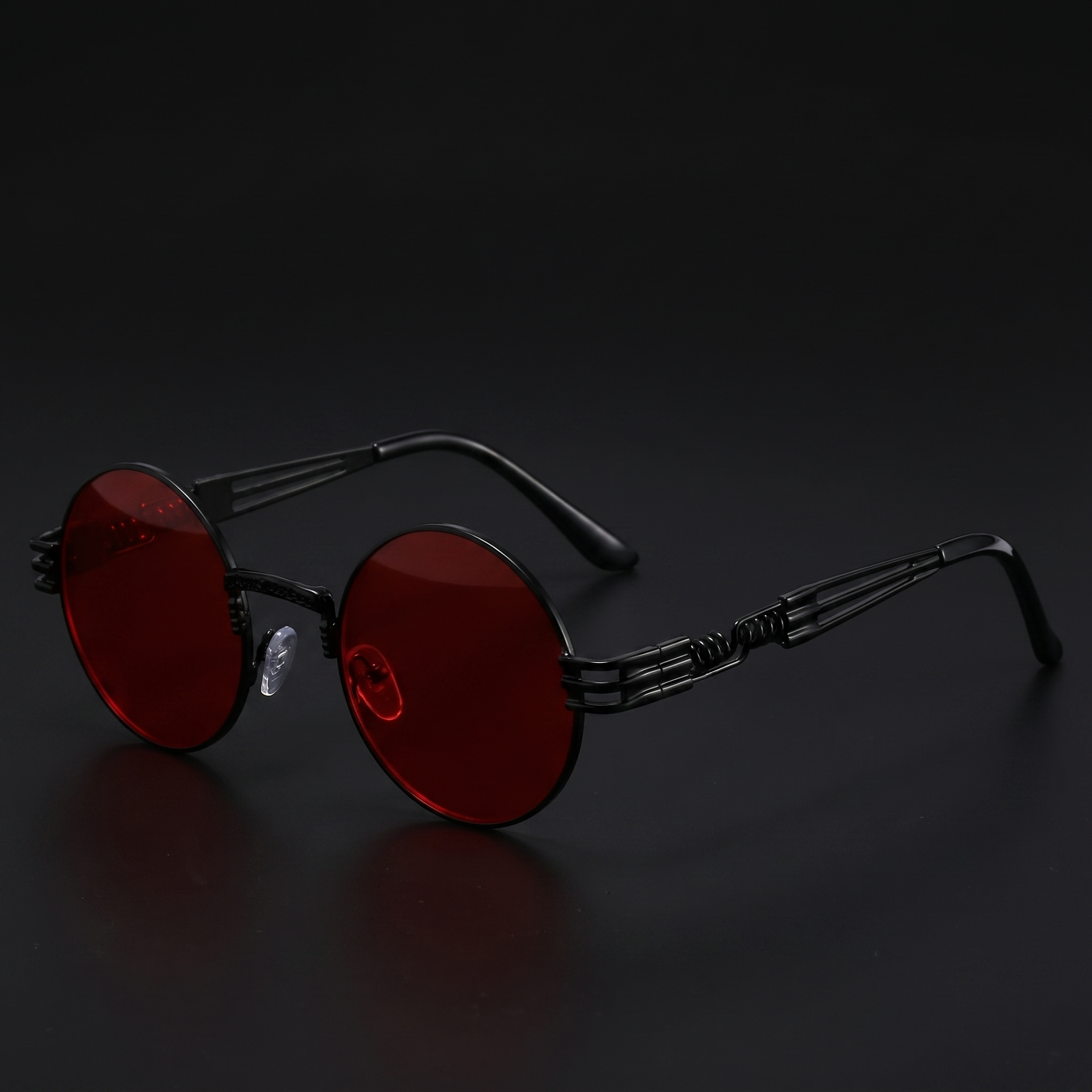 Black round steampunk sunglasses with red lenses and spring-temple metal frame