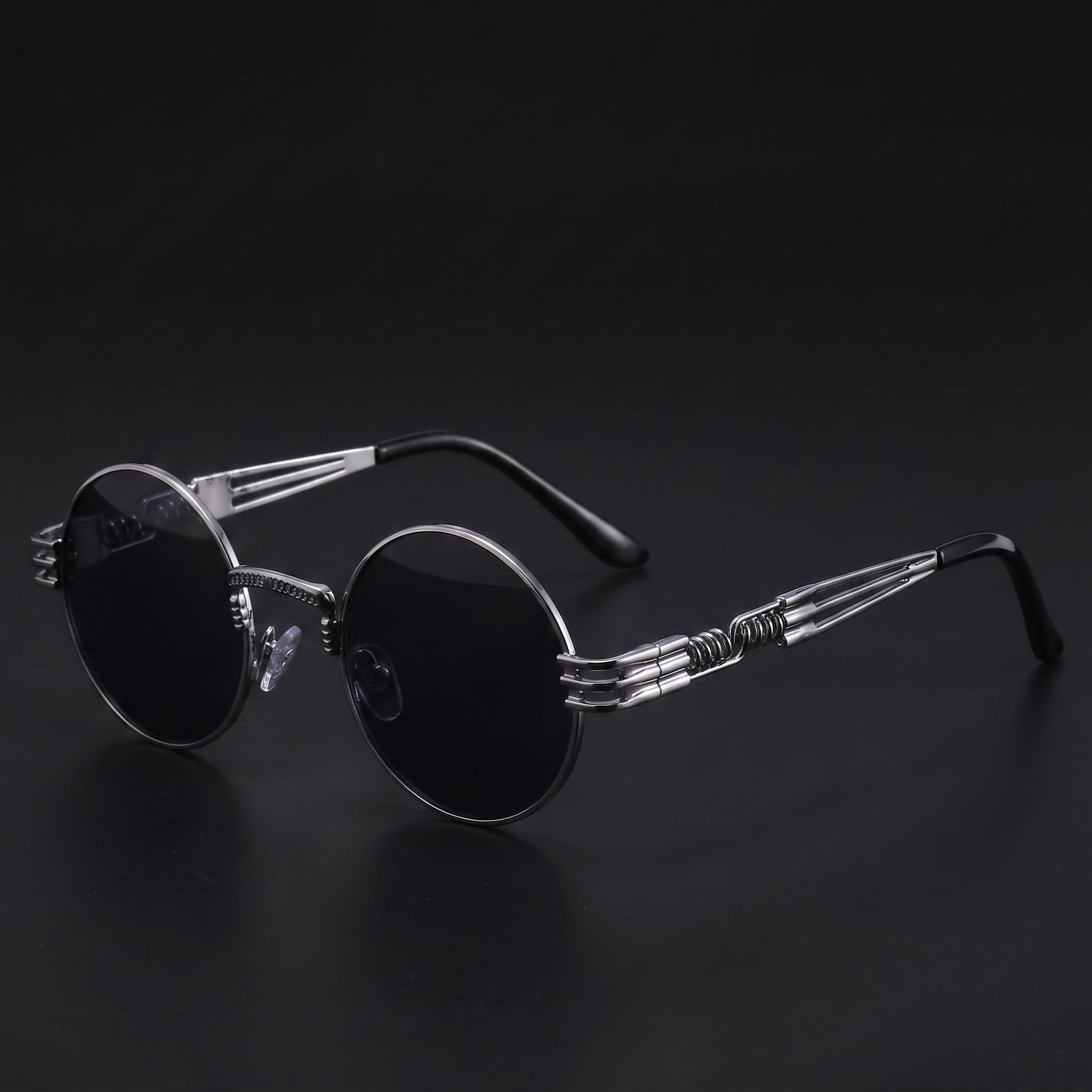 Silver round steampunk sunglasses with dark smoke lenses and spring temples