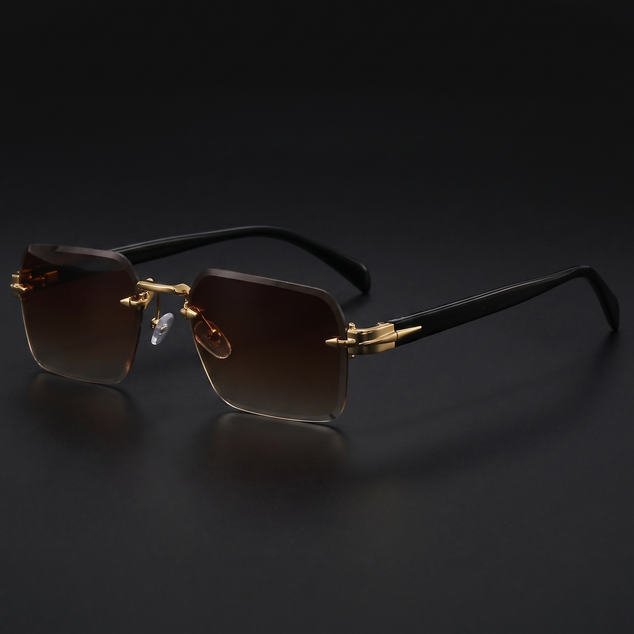Rimless gradient sunglasses close-up in Brown gradient, gold hardware and black temples