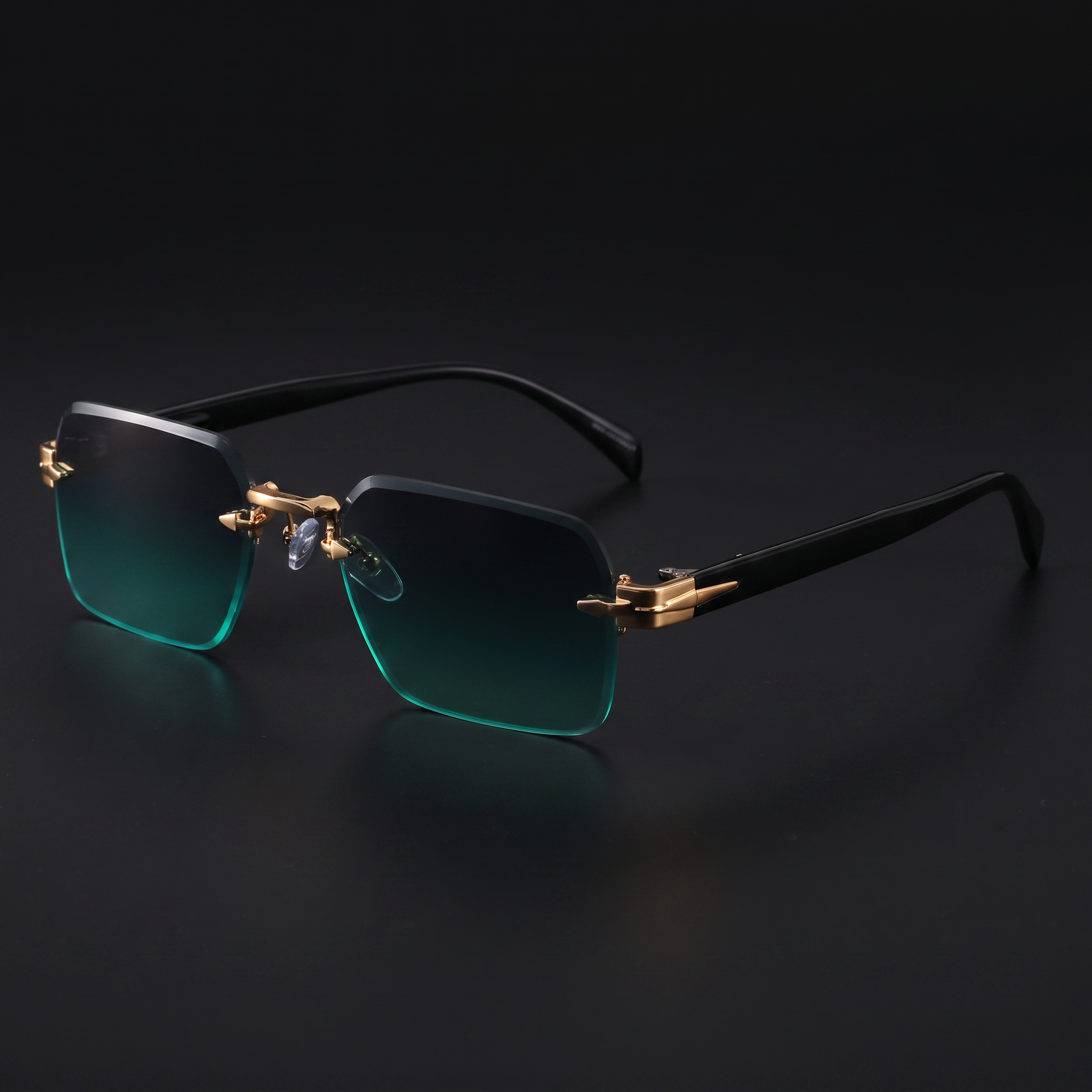 Rimless gradient sunglasses close-up in Gold Green, gold spearhead hardware and black temples