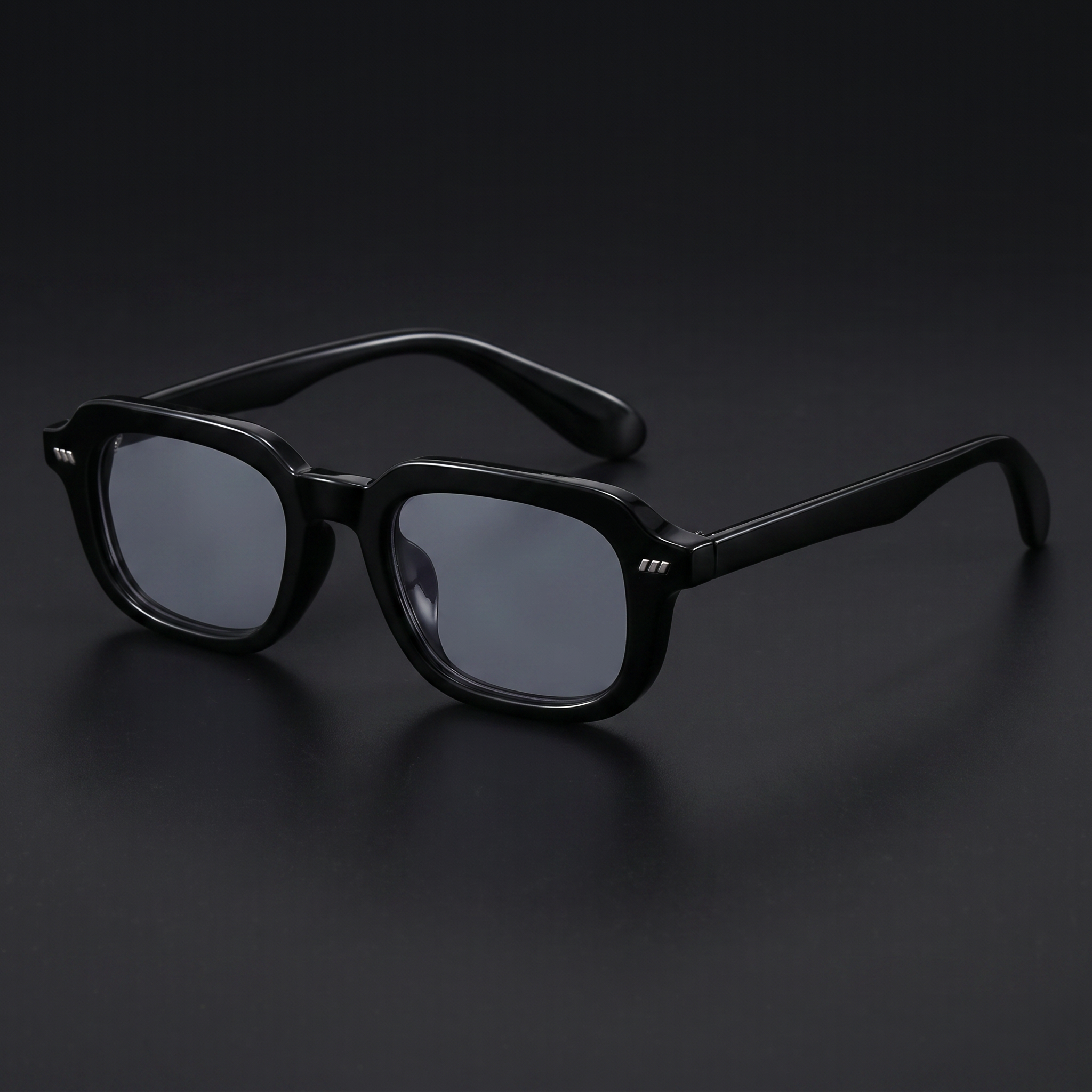 Small square Y2K sunglasses in black with smoke-grey lenses, studio close-up