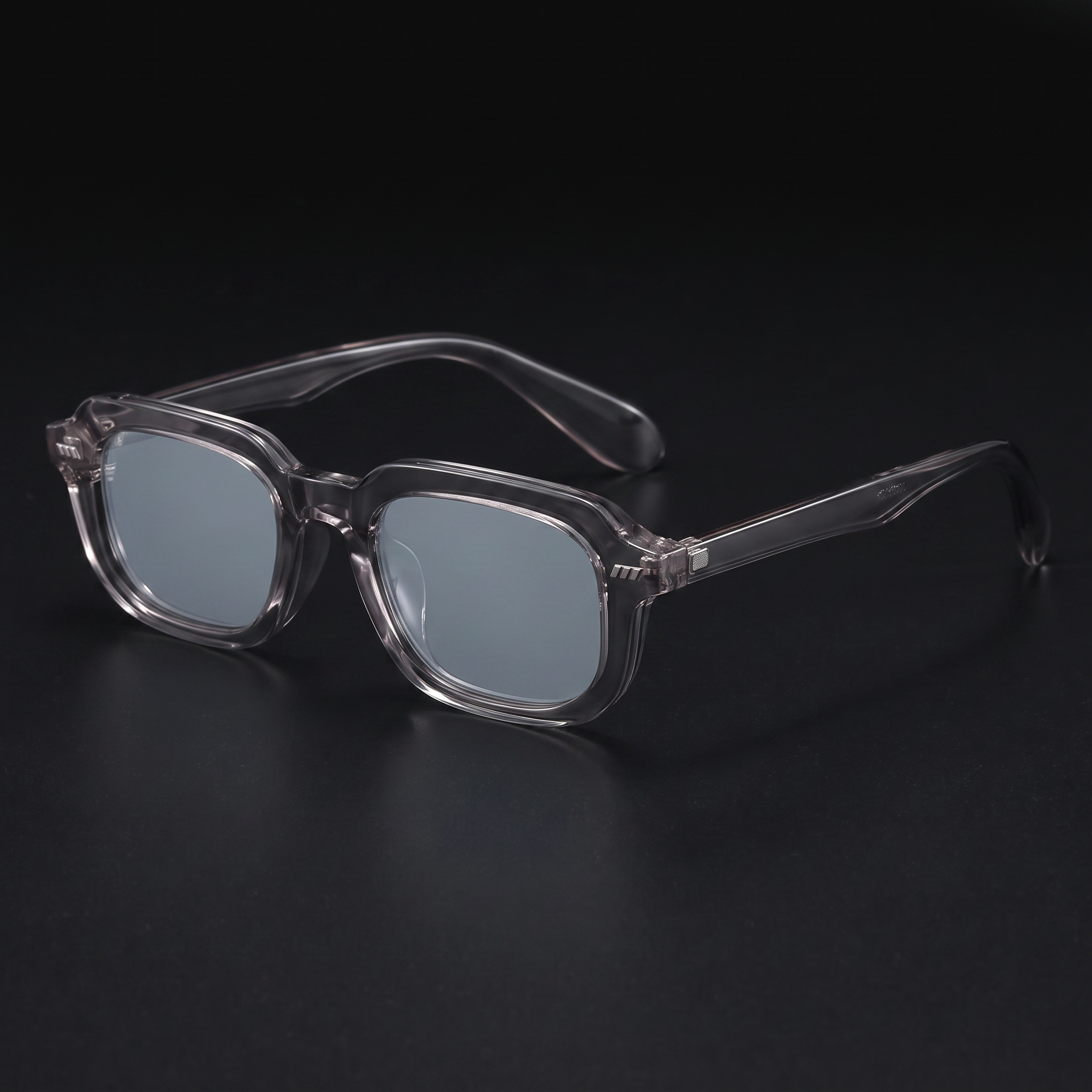 Small square Y2K sunglasses in translucent grey with grey lenses, studio close-up