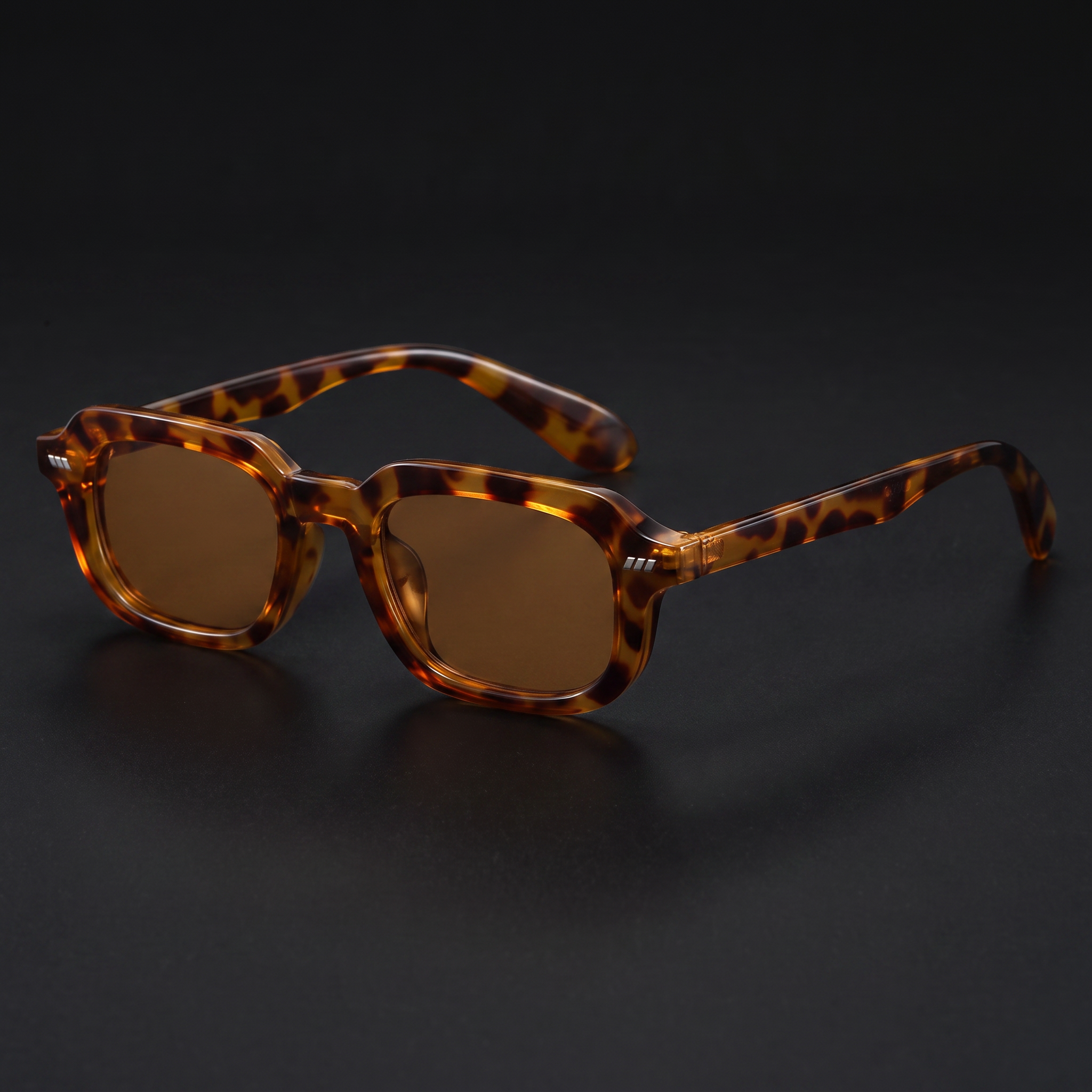 Small square Y2K sunglasses in tortoiseshell with brown lenses, studio close-up